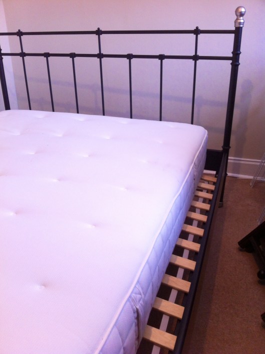 The final step! Place the mattress onto the bed. And note that it is about five inches too narrow for the frame you've spent all day assembling.