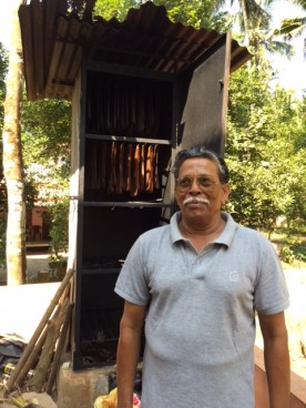 We stopped to visit Jaya's friend. Upon his recent retirement, he and his wife built their beautiful house near their family home. The airy house was surrounded by beautiful trees,  growing everything from coconut to banana to rubber. He showed us several pressed mats of harvested rubber hanging on lines waiting to be smoked, as well as the mats he was smoking to a glossy black finish.