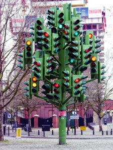 British traffic humor: I encountered this in the middle of a roundabout. I cried. [Image credit: Traffic-light-tree by Pierre Vivant. ]